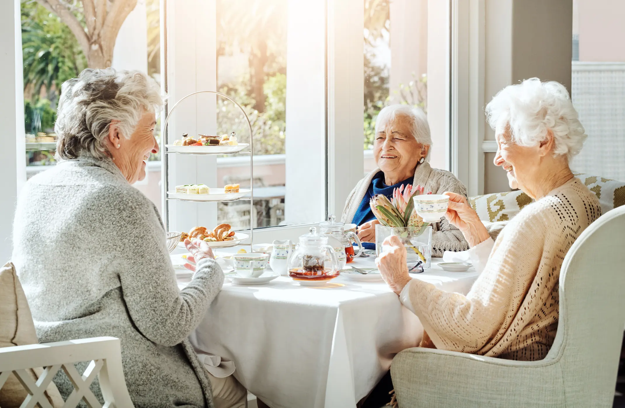 Happy senior women having tea in a retirement home